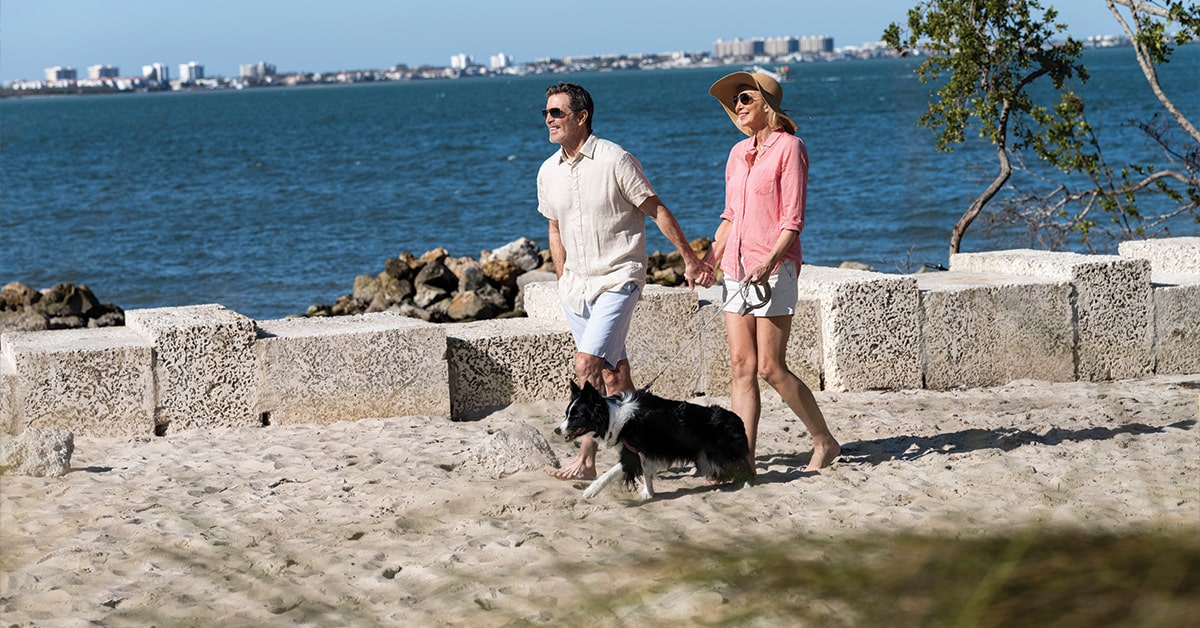 couple walking their dog along Sarasota Bay Park