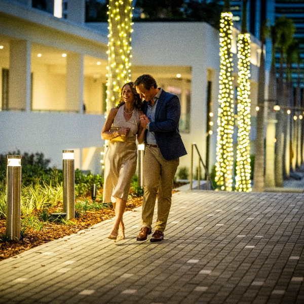 Couple walking at dusk along The Quay Sarasota promenade